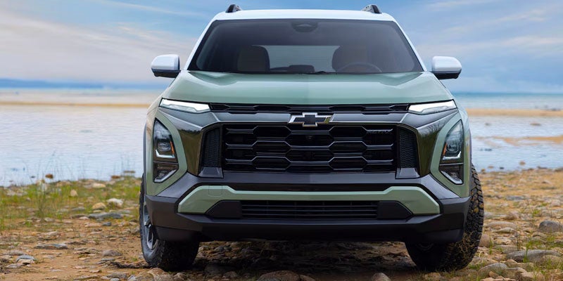 A green suv sitting parked.