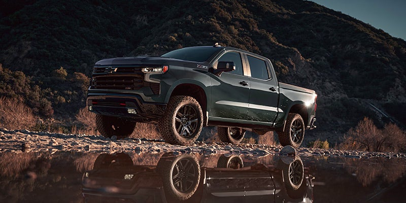 A green truck sitting parked.