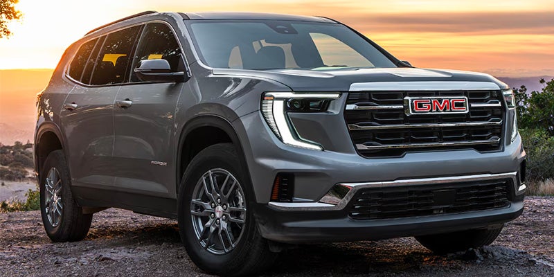 A silver suv sitting parked.