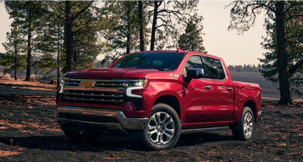 a red 2025 chevrolet silverado parked in the woods