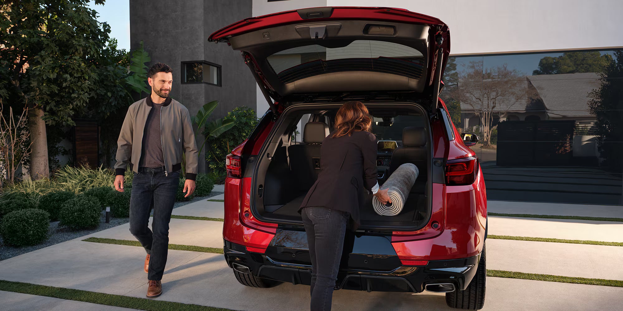 Two people getting in the truck of a blazer.