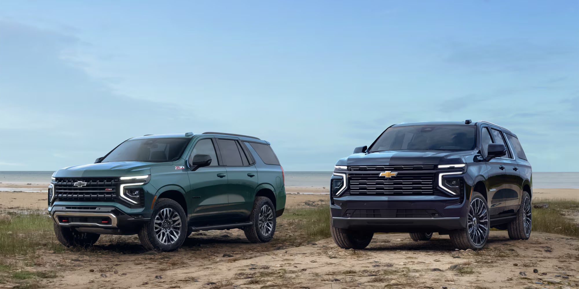 Two suvs sittin parked.