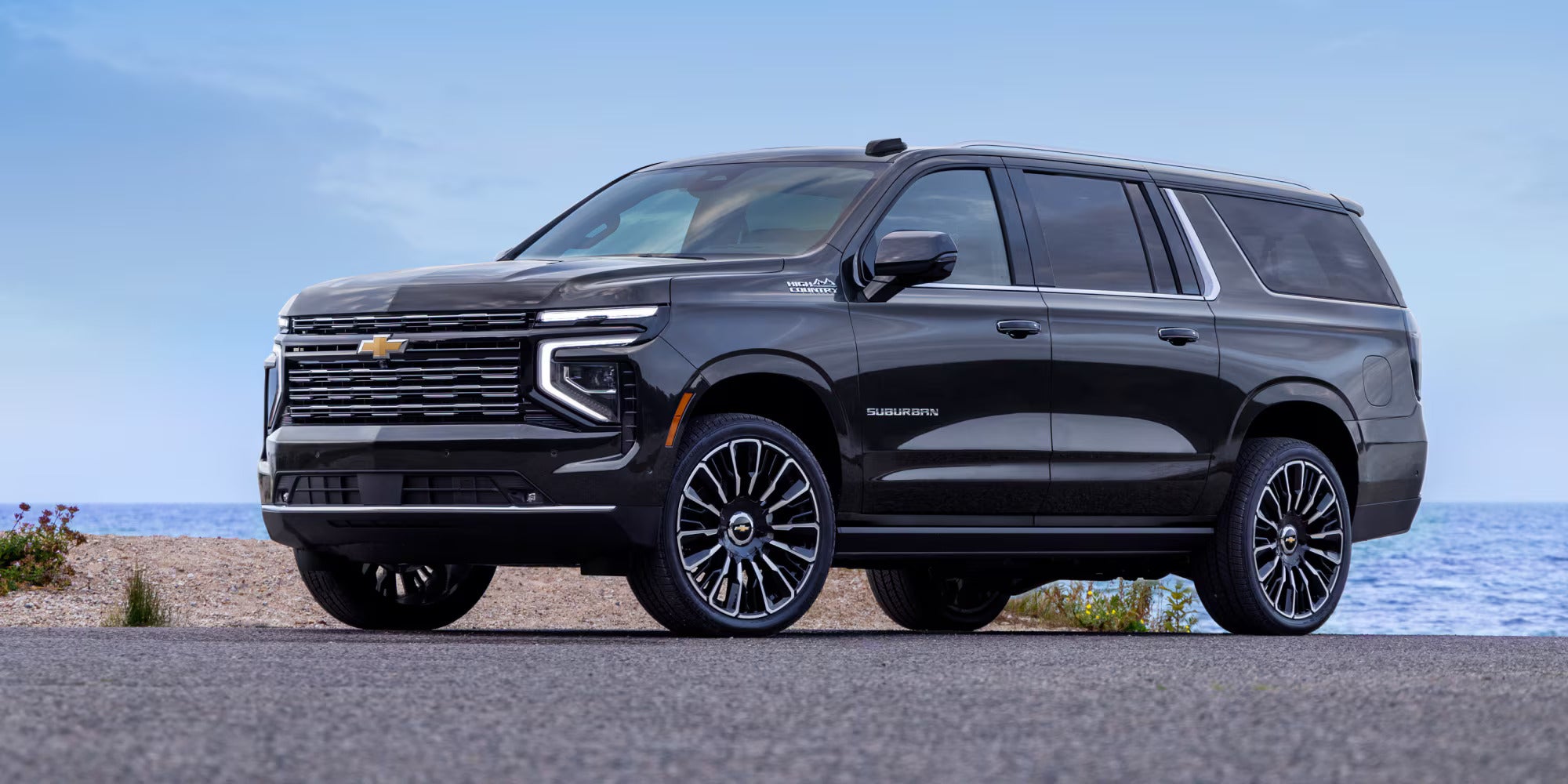 A black suv sitting on the road.