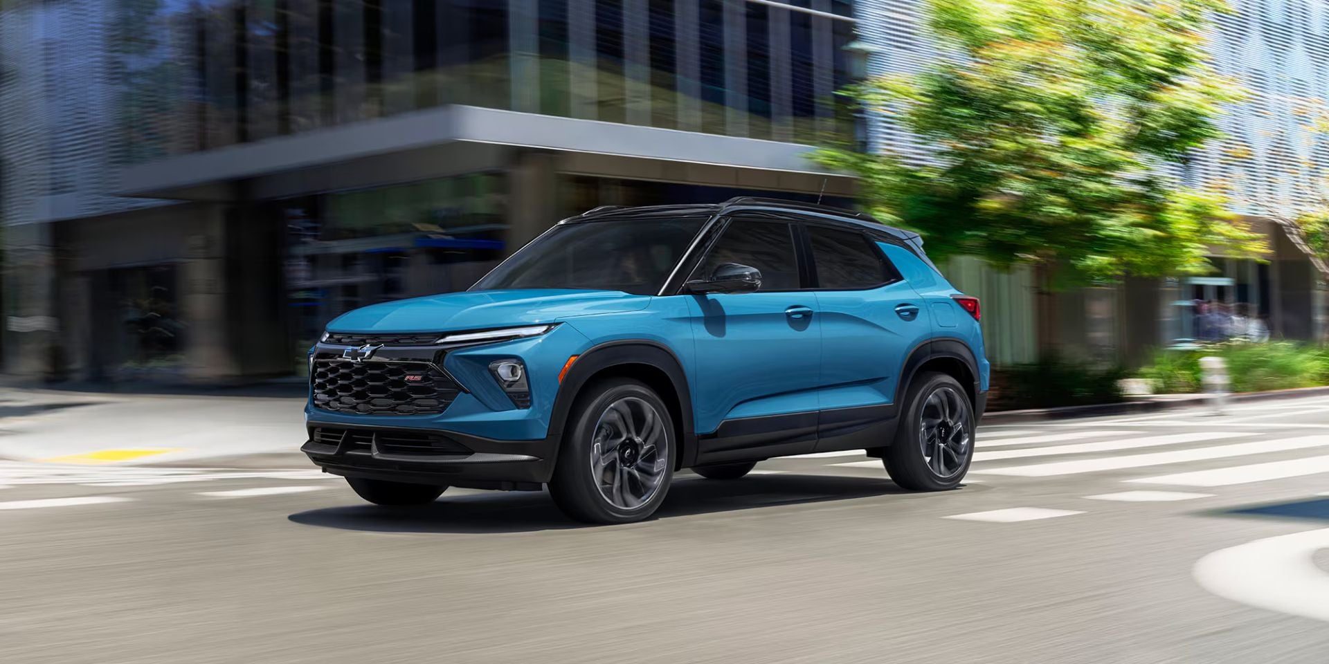 A blue suv driving on the road.