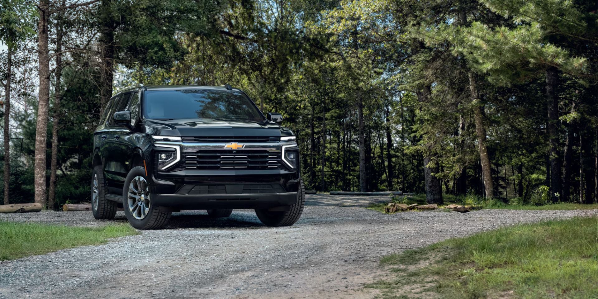 A green suv sitting parked in a driveway.