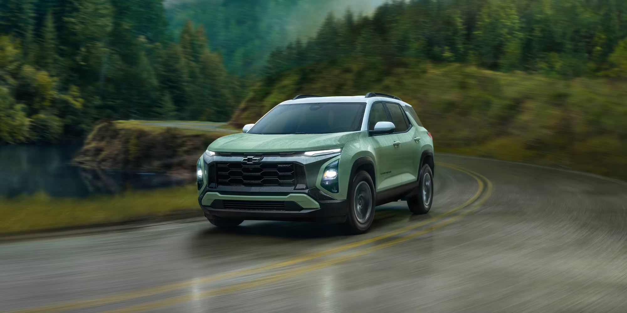 A green suv driving along the road.