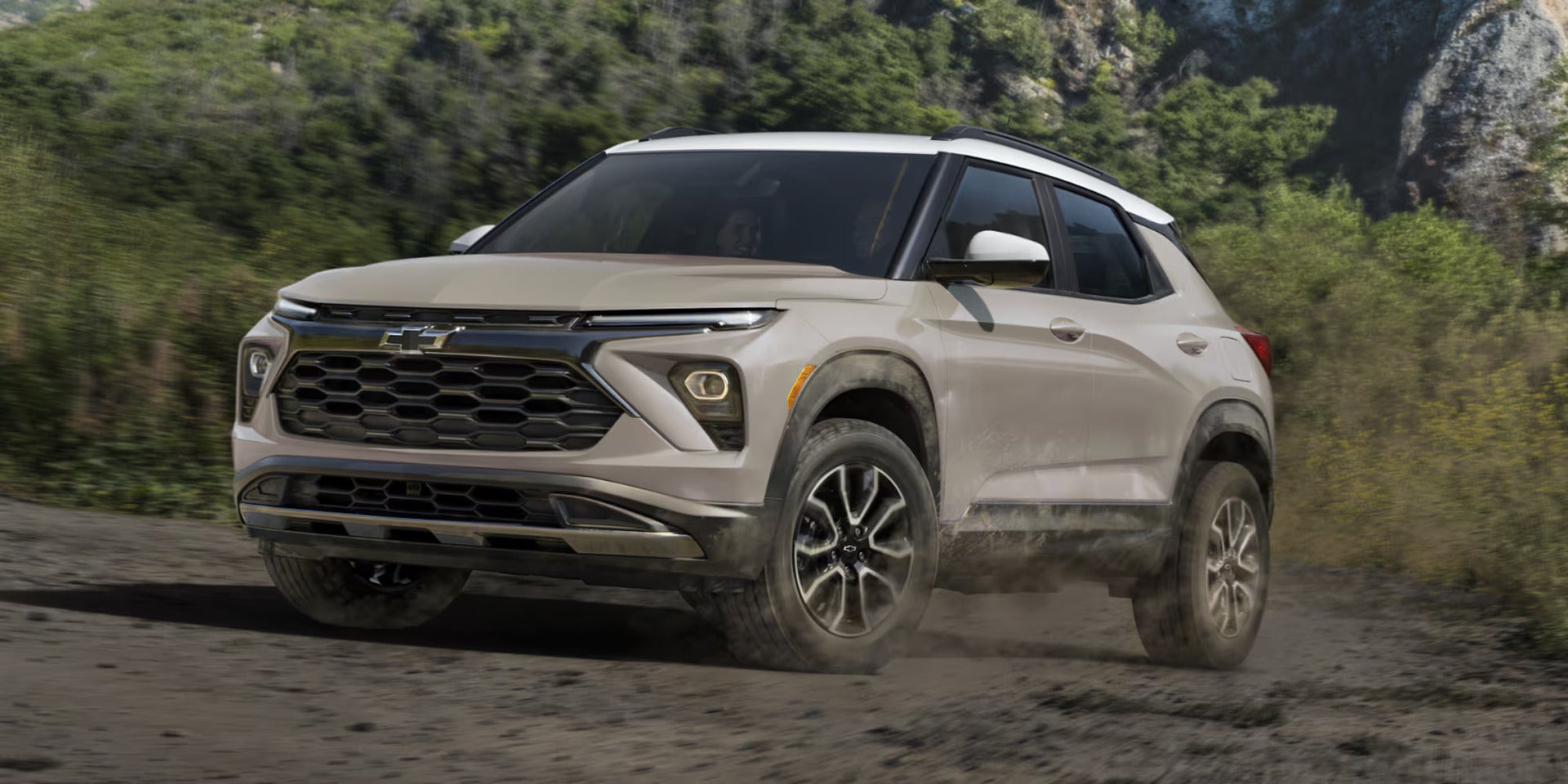 A tan suv driving off-road.