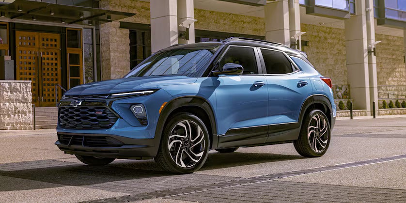 A blue suv sitting on the side of the road.