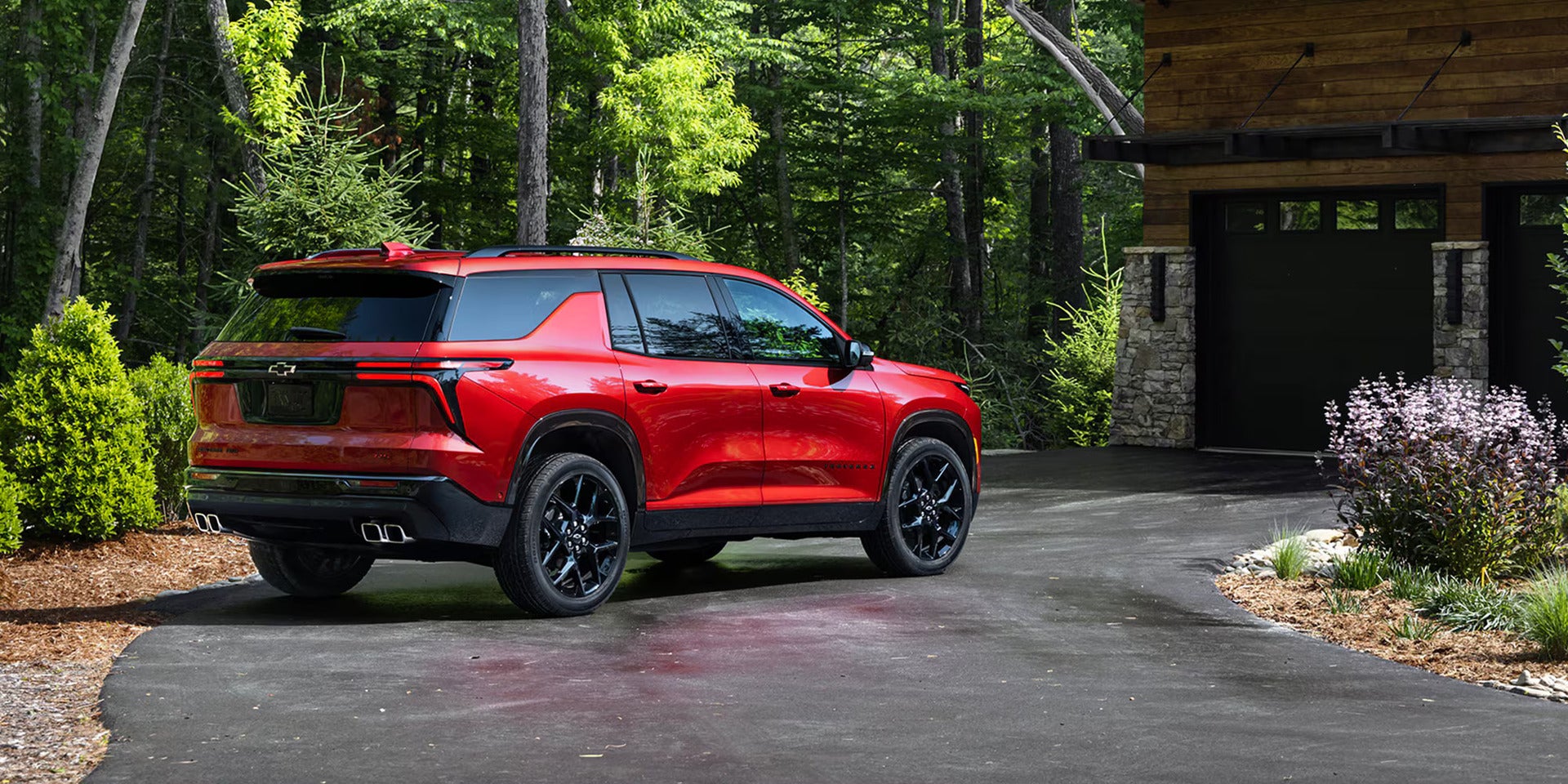 A red suv sitting in a driveway.